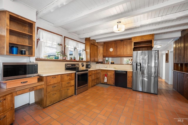kitchen with stainless steel appliances, light countertops, beamed ceiling, brown cabinets, and brick floors