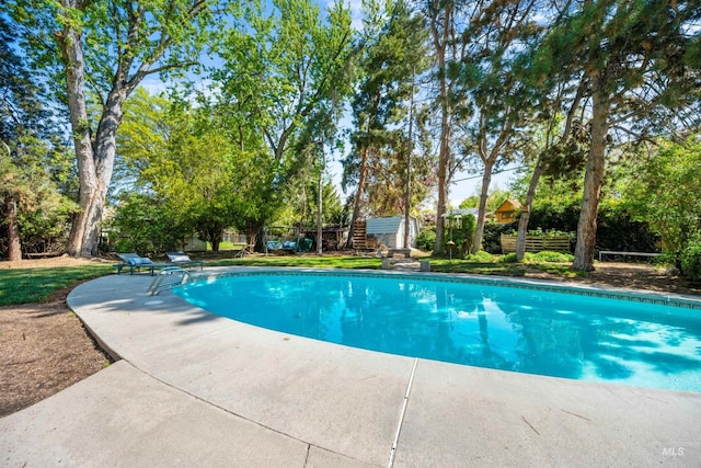 swimming pool featuring fence and a patio