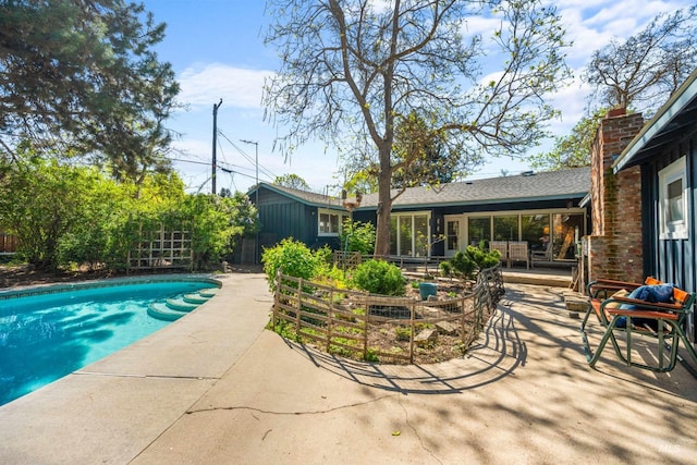 swimming pool with a patio area, fence, and outdoor lounge area