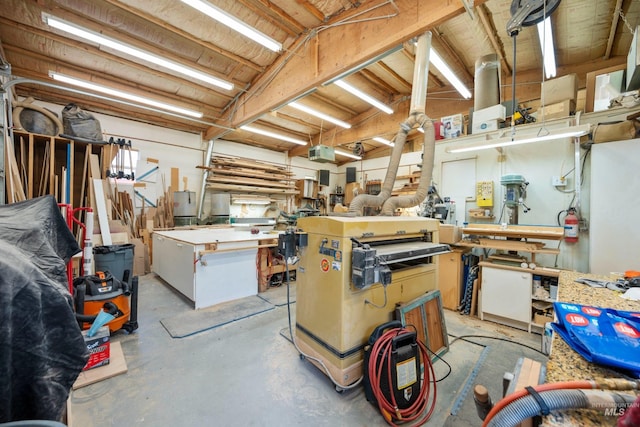 misc room with a workshop area and unfinished concrete flooring