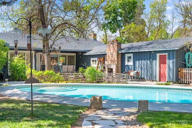 swimming pool with fence and a patio
