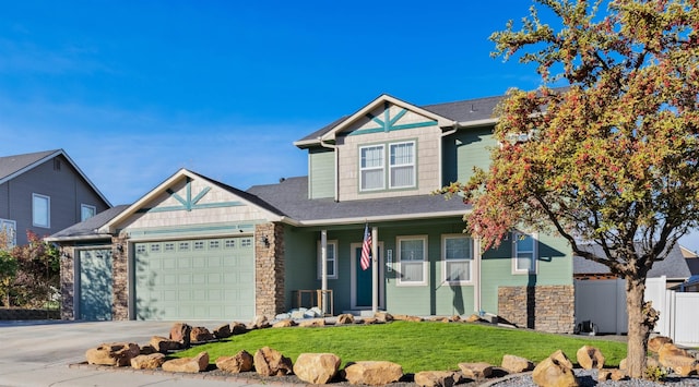 craftsman house featuring a garage, covered porch, and a front yard