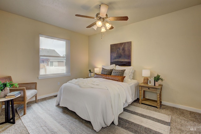 bedroom with ceiling fan and light carpet