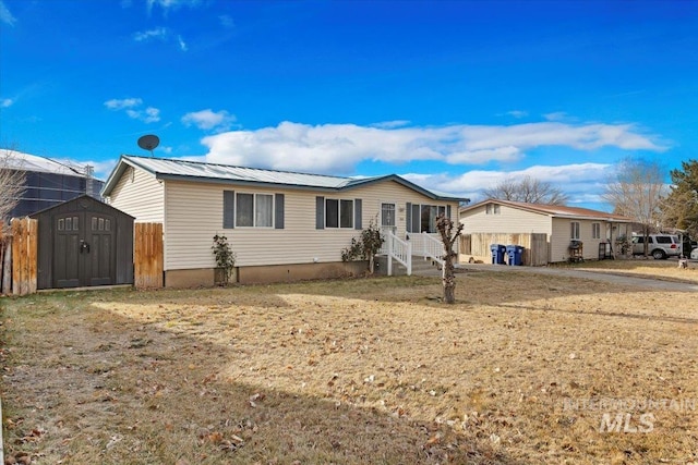 single story home with a shed