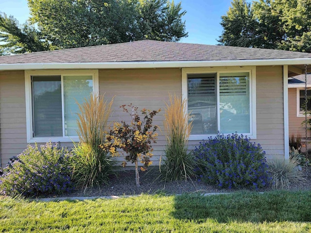 view of side of home with a lawn