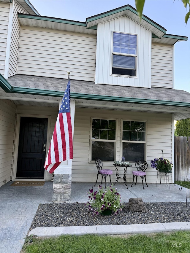 property entrance with a porch and board and batten siding