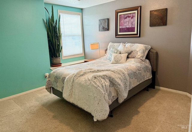 carpeted bedroom with baseboards