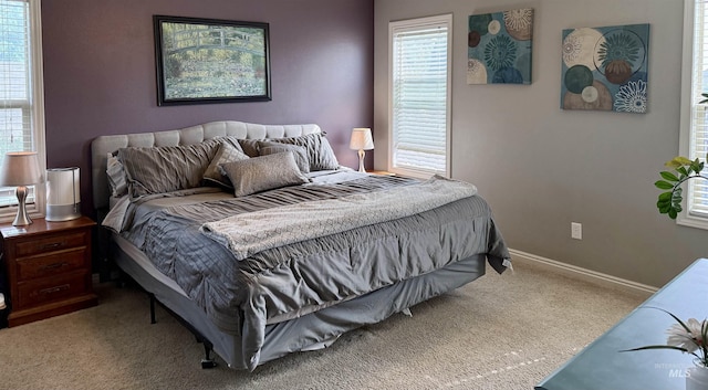 carpeted bedroom featuring baseboards