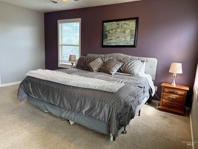 bedroom featuring carpet and baseboards