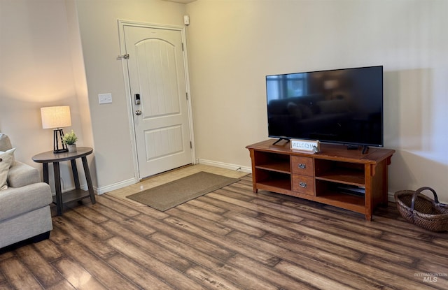 living area with wood finished floors and baseboards