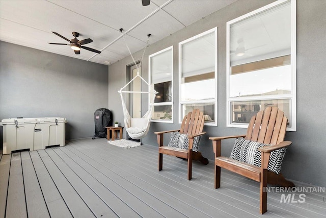 sunroom featuring ceiling fan