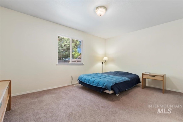 bedroom featuring carpet and baseboards
