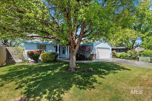 obstructed view of property with an attached garage and concrete driveway