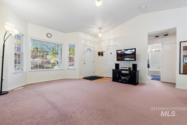 unfurnished living room featuring carpet, lofted ceiling, and baseboards