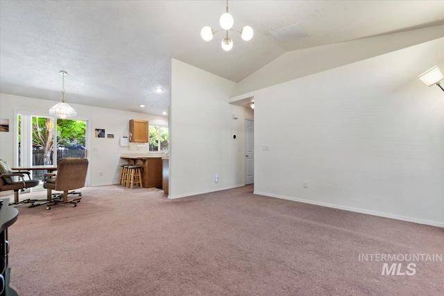 living area with light carpet, vaulted ceiling, baseboards, and a chandelier
