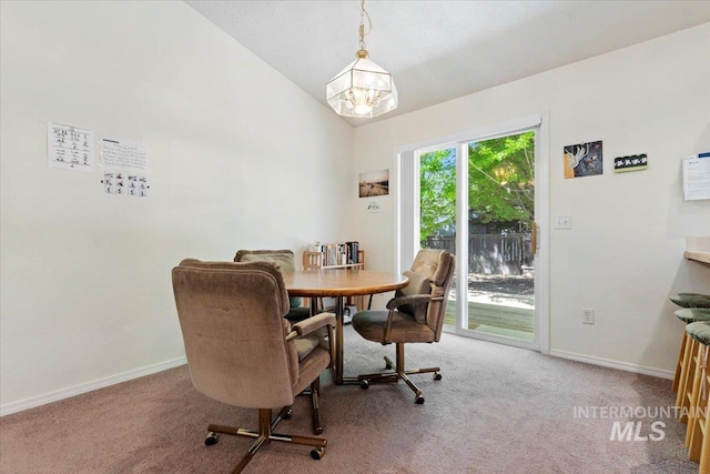 dining area featuring a chandelier, carpet flooring, lofted ceiling, and baseboards