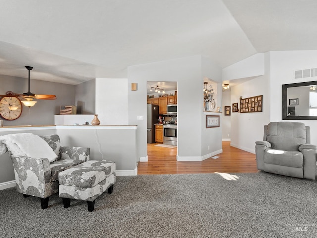 carpeted living room with lofted ceiling and ceiling fan