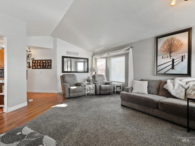 living room featuring lofted ceiling and wood-type flooring