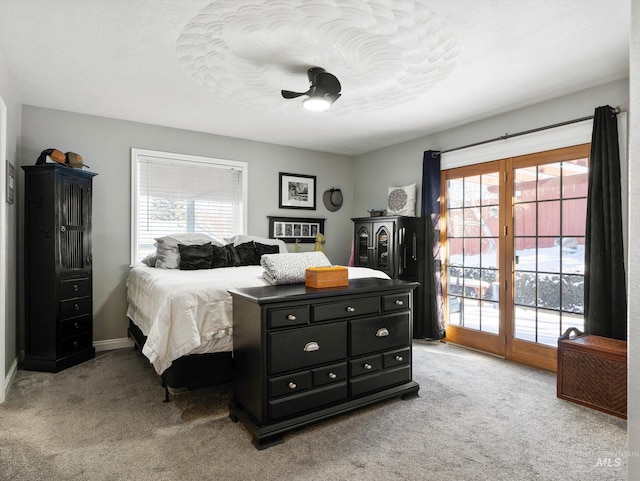 carpeted bedroom featuring a textured ceiling, multiple windows, and access to outside