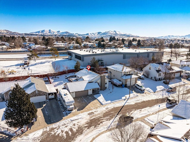 snowy aerial view featuring a mountain view