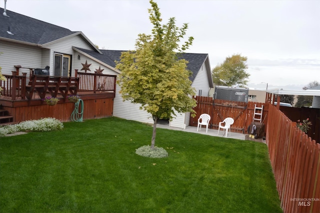 view of yard featuring a deck and a patio