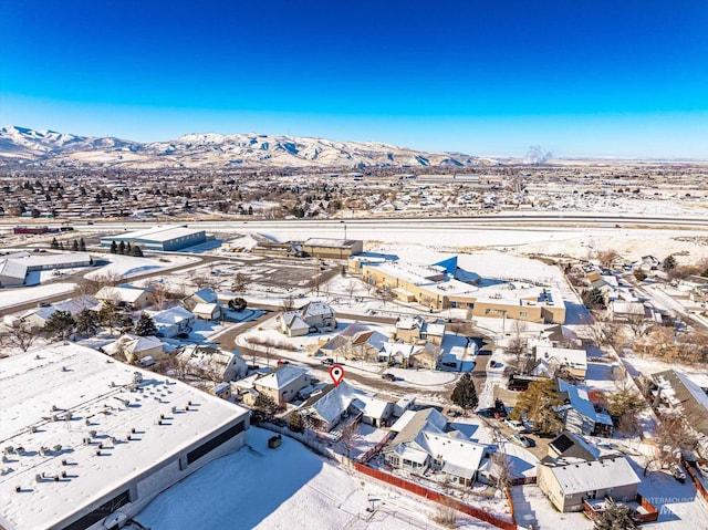 snowy aerial view featuring a mountain view