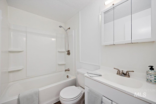 bathroom with vanity, bathtub / shower combination, toilet, and a textured ceiling