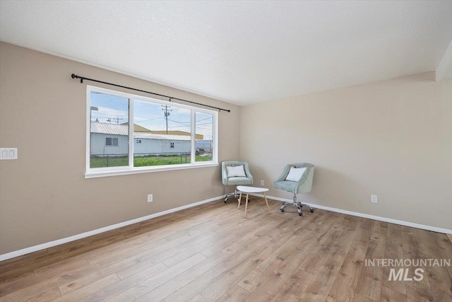 unfurnished room featuring baseboards and wood finished floors