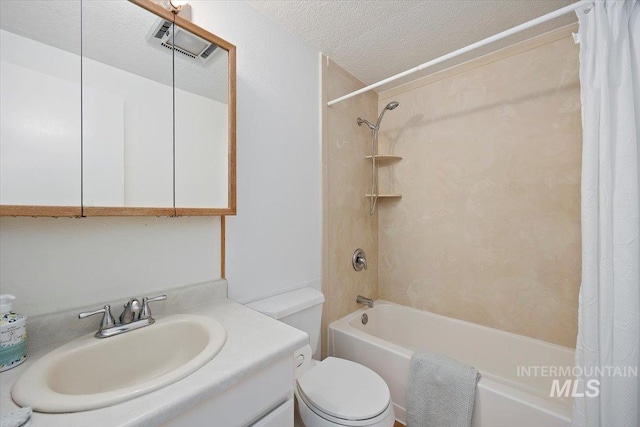 bathroom with vanity, toilet, a textured ceiling, shower / tub combo, and visible vents