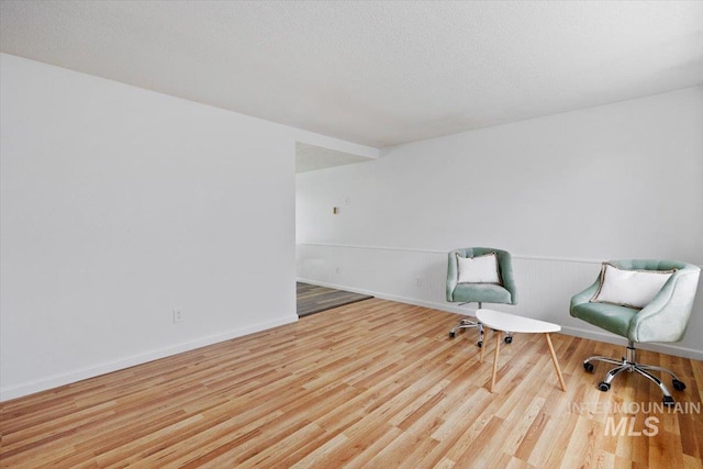 unfurnished room with baseboards and wood finished floors