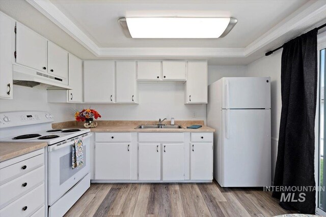 kitchen featuring a sink, white cabinets, under cabinet range hood, and white appliances