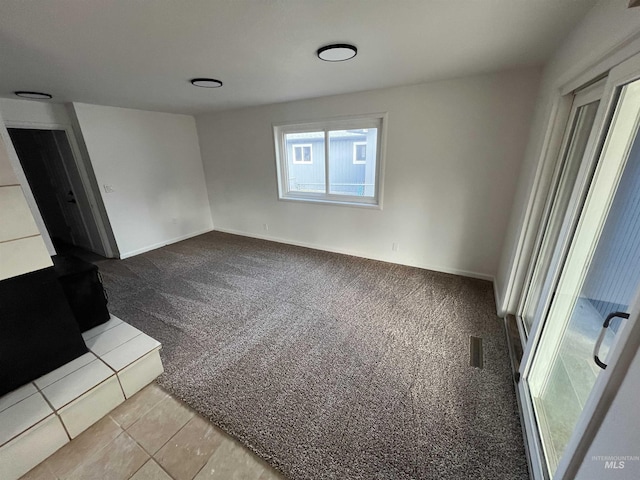 interior space featuring visible vents, baseboards, and carpet floors