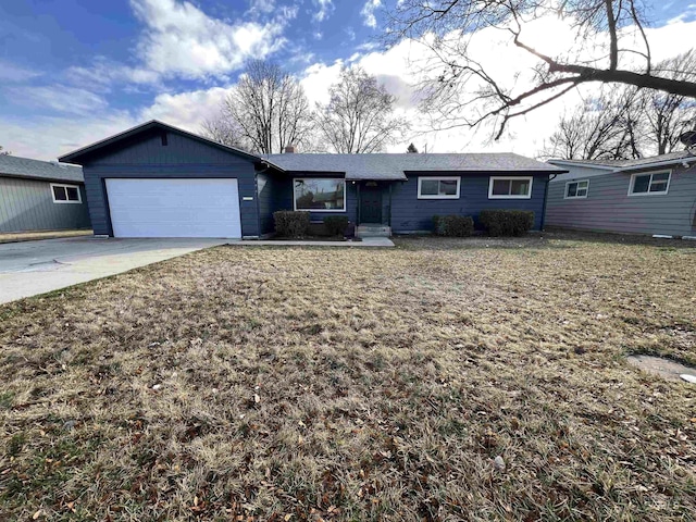 ranch-style house featuring a garage, a front yard, and driveway