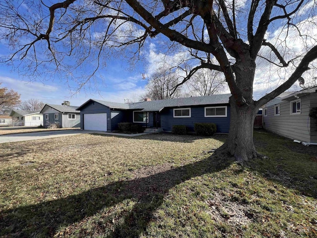 view of front of home with a front lawn, concrete driveway, and an attached garage