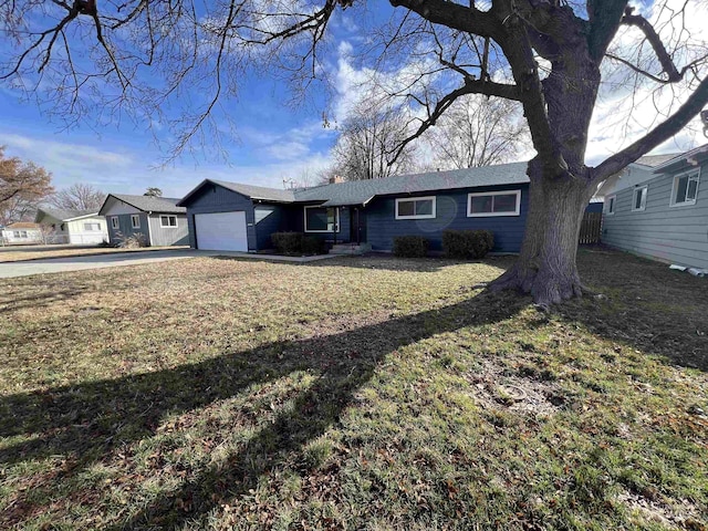 ranch-style house with driveway, a front lawn, and an attached garage