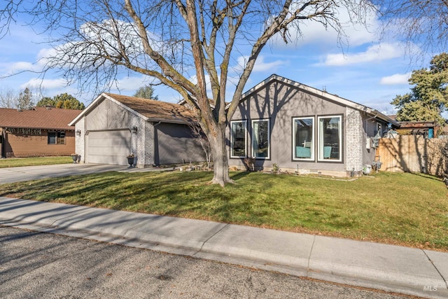 view of front of property with a front yard and a garage