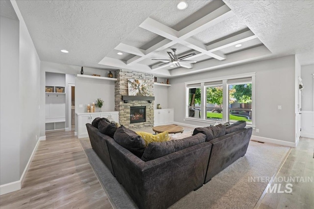 1753 S Kimball Way, Boise, ID 83709 - living room featuring light wood finished floors, a fireplace, baseboards, a textured ceiling, and ceiling fan