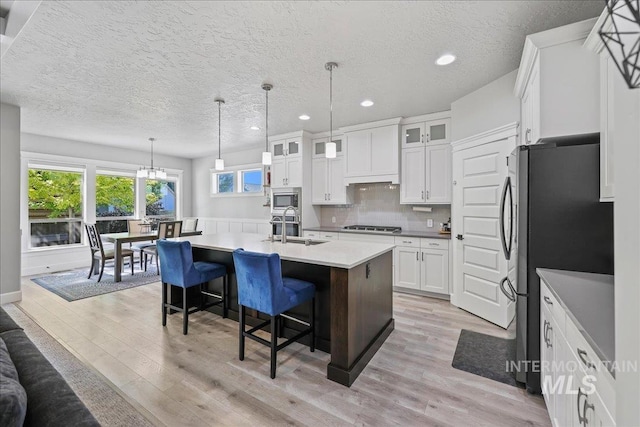 1753 S Kimball Way, Boise, ID 83709 - kitchen with a sink, recessed lighting, stainless steel appliances, light wood-type flooring, and white cabinets