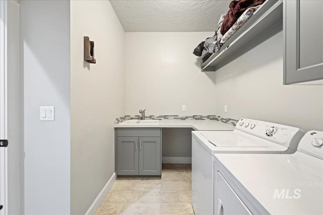 1753 S Kimball Way, Boise, ID 83709 - laundry area featuring washing machine and dryer, cabinet space, a textured ceiling, and baseboards