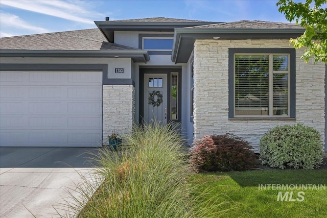 1753 S Kimball Way, Boise, ID 83709 - view of front facade with an attached garage, stucco siding, stone siding, and concrete driveway