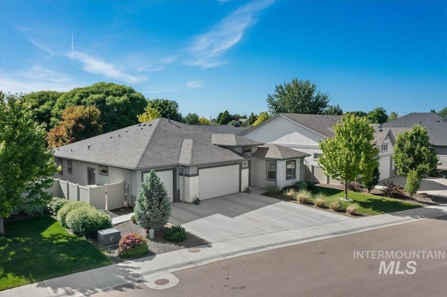 1753 S Kimball Way, Boise, ID 83709 - view of front of home with an attached garage, driveway, stucco siding, and roof with shingles