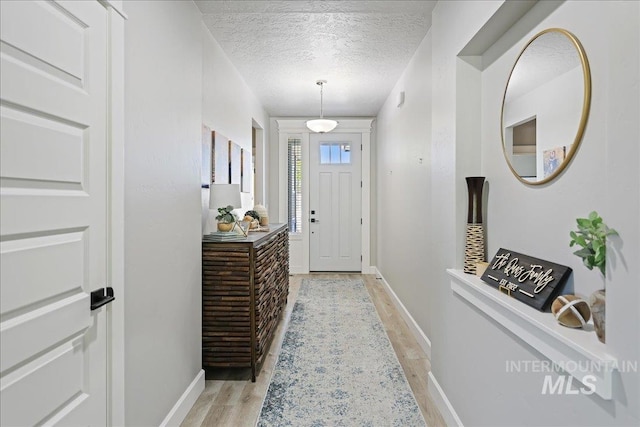 1753 S Kimball Way, Boise, ID 83709 - foyer featuring light wood-style flooring, a textured ceiling, and baseboards
