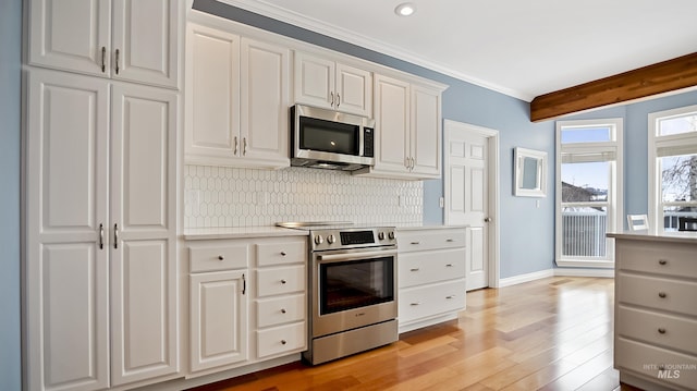 kitchen with backsplash, stainless steel appliances, light countertops, and light wood finished floors