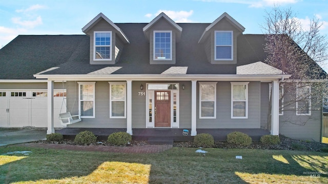 view of front of house featuring a garage, a porch, roof with shingles, and a front yard