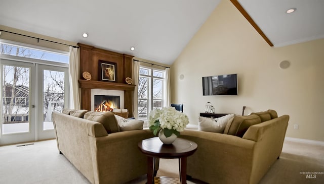 living area with french doors, a fireplace, light colored carpet, high vaulted ceiling, and baseboards