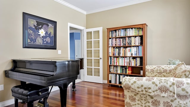 living area featuring ornamental molding and wood finished floors