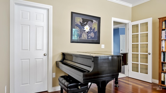 sitting room featuring crown molding and wood finished floors