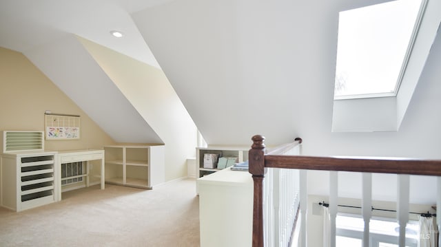 hallway featuring carpet floors, vaulted ceiling with skylight, plenty of natural light, and recessed lighting