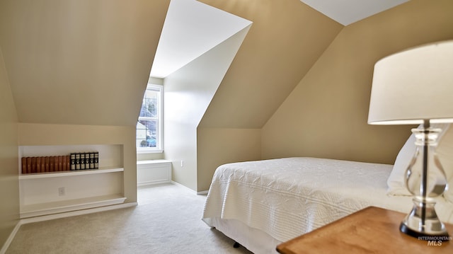 bedroom featuring carpet, baseboards, and vaulted ceiling