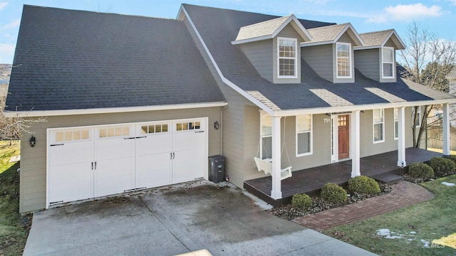 view of front of property featuring an attached garage, a shingled roof, a porch, and concrete driveway